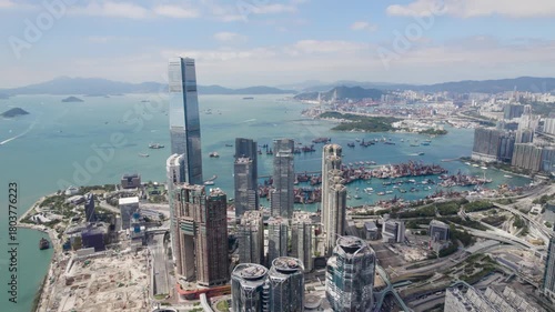Hong Kong bay area, aerial view over the Kowloon district looking towards the Central District Island on a beautiful sunny day in 4K