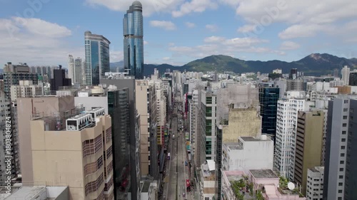 Hong Kong City fly-through Kowloon District between buildings down the Nathan road, aerial view of a densely populated Mong Kok area