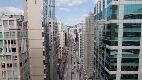 Hong Kong City fly-through Kowloon District between buildings down the Nathan road, aerial view of a densely populated Mong Kok area