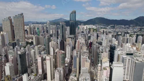 Hong Kong City, Kowloon District, aerial top view of a densely populated Mong Kok area and the famous Nathan road with a lot of residential and office buildings.