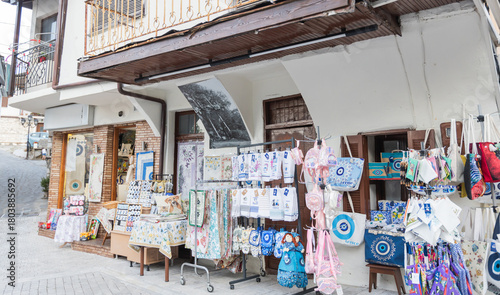 Traditional Greek souvenir shop with local textiles and handmade crafts in a village street