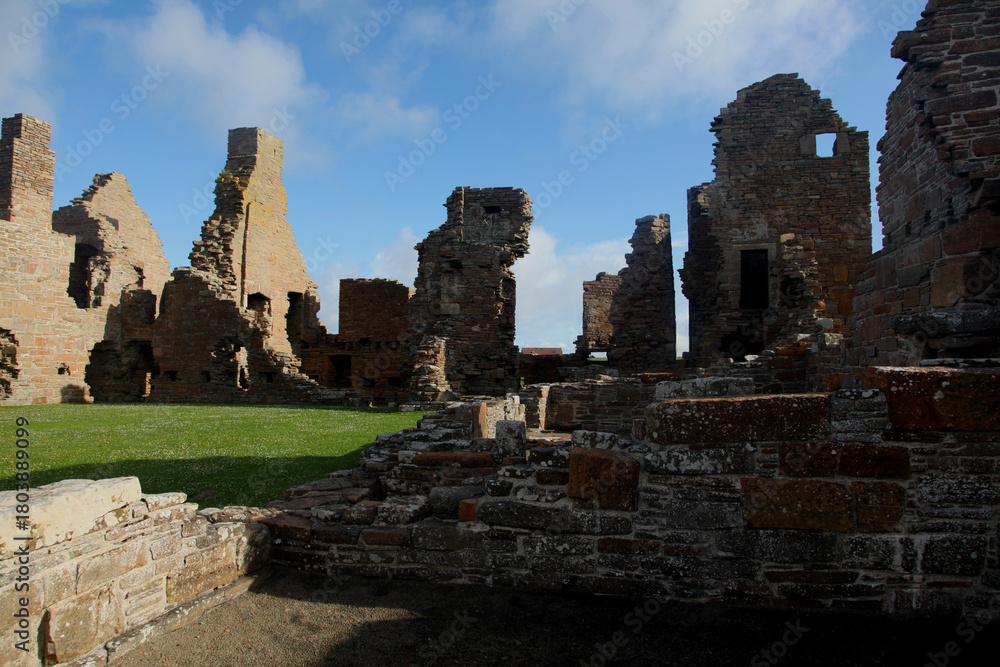 Naklejka premium Ruins of the Earls Palace landmark in Kirkwall, Orkney, a moody historic 16th-century Renaissance fortress featuring crumbling archways, aged stonework, and atmospheric courtyards.