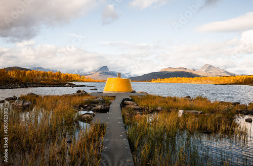 Yellow beacon tower at border intersection of Finland Sweden Norway