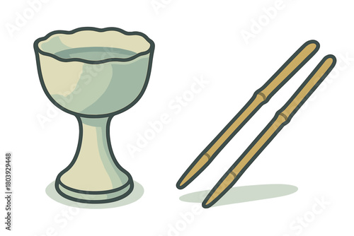 Traditional Japanese ceramic sake cup filled with rice wine next to bamboo chopsticks