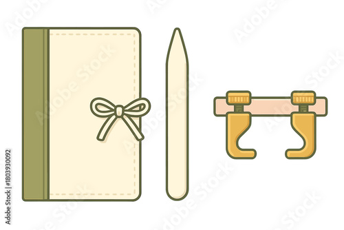 Traditional bookbinding tools and materials: bone folder, clamps, and book cover