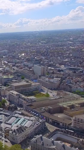 4K vertical aerial drone video over Brussels city centre. Cinematic high-altitude footage of European capital skyline, historic buildings, skyscrapers, green parks. Premium mobile, social media video.