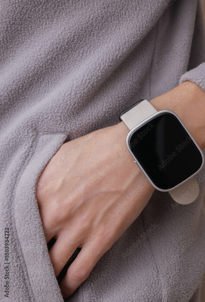 Fototapeta premium Workout accessories. Smart bracelet on a fitness woman's wrist. Active lifestyle, sport outfit