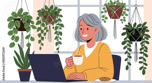Woman working on laptop with coffee surrounded by plants.