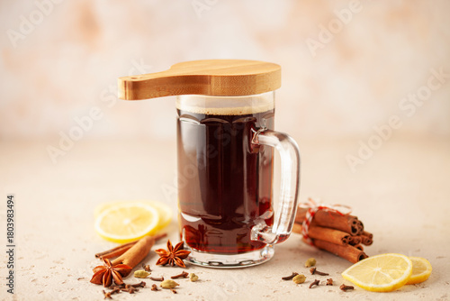German christmas drink glühbier. Hot beer with spices -  cinnamon, anise stars, citrus and gloves. Mulled dark beer.