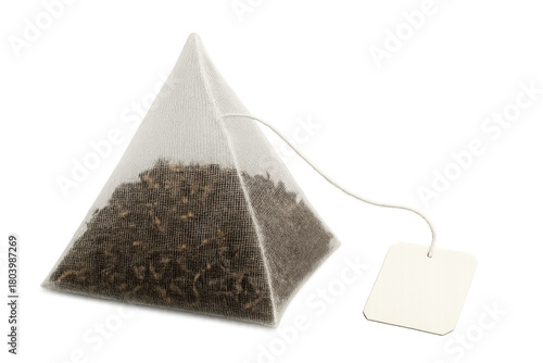 Pyramid tea bag with loose leaf tea and string awaiting infusion, morning beverage preparation, transparent background