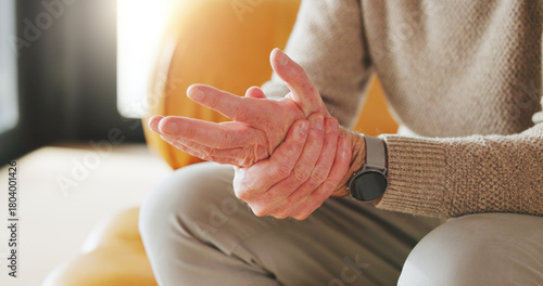 Senior person, massage and hand pain at house from arthritis, carpal tunnel and joint stiffness. Closeup, elderly man and muscle strain from osteoporosis, poor circulation and inflammation discomfort