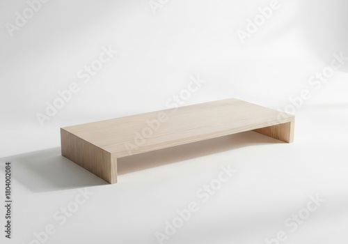 Minimalist light wood monitor stand on white background
