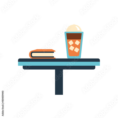 Book and iced drink on a table.