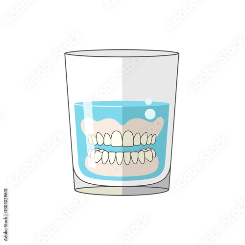 Denture soaking glass with false teeth in cleaning solution  