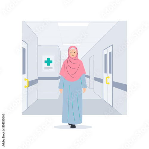 Young Muslim woman walking in hospital corridor wearing hijab  