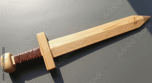 Handcrafted wooden toy sword with leather wrapped hilt on a gray surface