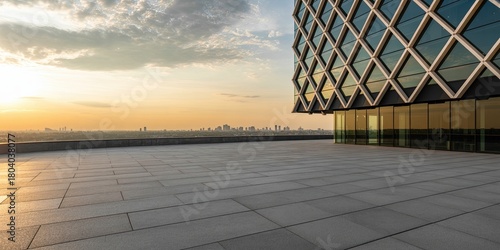 Modern building rooftop with stunning city skyline view bathed in warm golden sunset