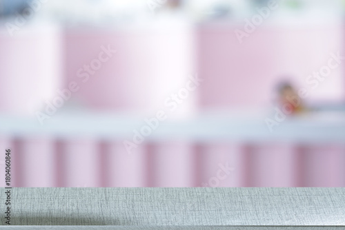 Wooden table surface separating blurred cafe background
