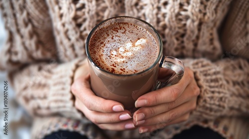 Cozy winter scene  warm chocolate mug in hand emphasizing comfort and holiday spirit