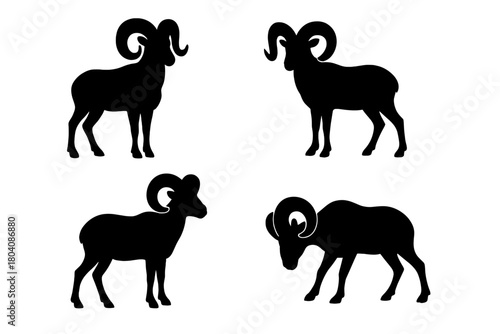 Set of four black ram or bighorn sheep silhouettes with large curved horns in various standing poses