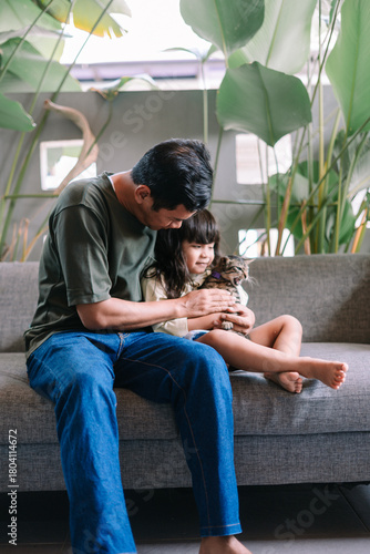 Loving Father and Daughter Share a Tender Moment with Pet Cat