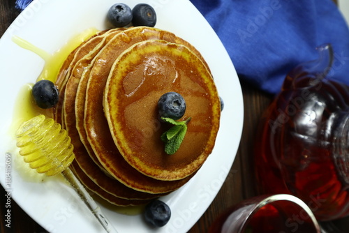Tasty homemade pancakes with honey and berries