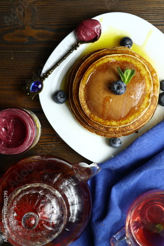 Tasty homemade pancakes with honey and berries