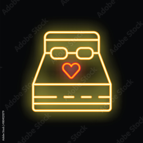Yellow neon sign representing a bed for honeymoon with a heart shape and two glasses on a black background