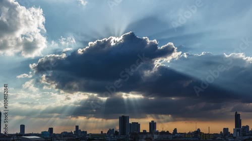 Time-lapse of Sunlight breaks through the clouds, forming bright beams that stream across the sky.