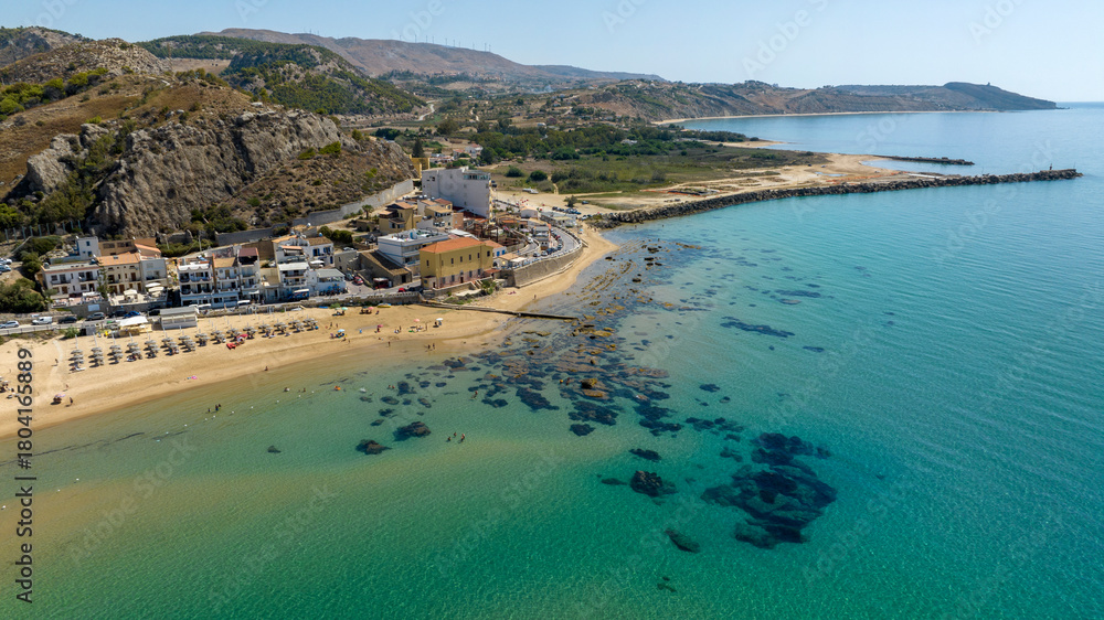Obraz premium Aerial view of the beach and coast of Siculiana Marina, in province of Agrigento, Sicily, Italy. It is a small coastal village overlooking the Mediterranean Sea, whose waters are blue and turquoise.