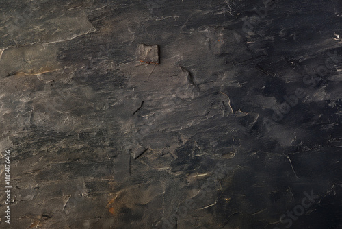 Textured dark slate stone background with natural minerals