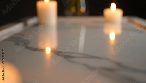 Candles illuminate a table with a subtle glow.