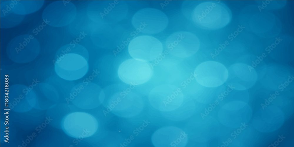 Bright blue bokeh background with defocused Christmas lights and glowing circles for a festive holiday design