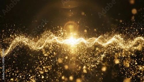 Golden particles flow with light burst.