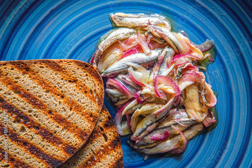 Quadro su tela Alici in saor, marinated anchovies with red onions.