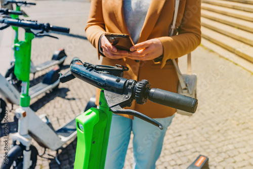 Woman tourist rents electric scooter by phone.