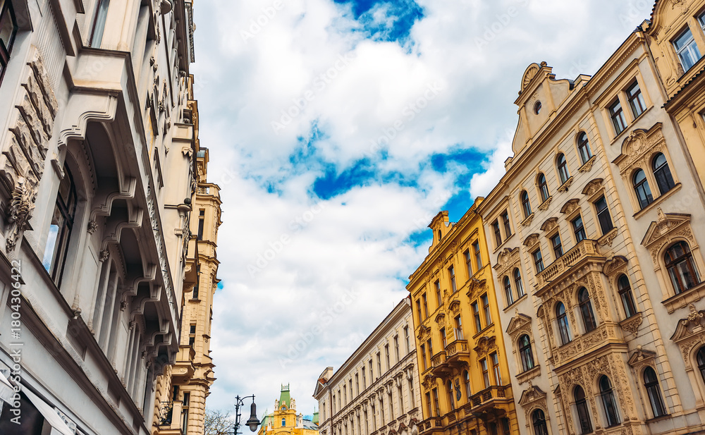 Obraz premium Colorful historic buildings line Prague street.