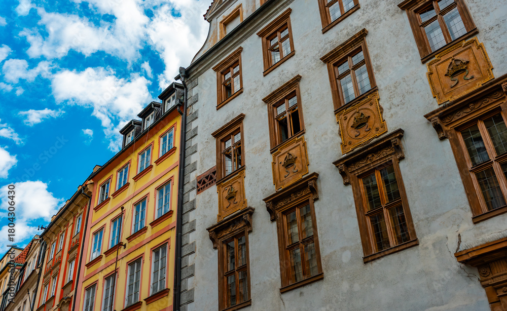 Naklejka premium Colorful historic buildings line Prague street.