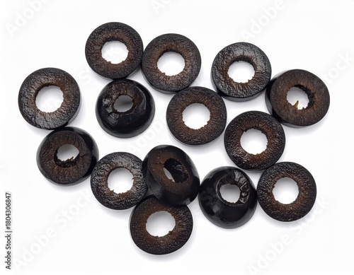 High-resolution image of sliced black olives arranged on a white background, ideal for culinary and food-related projects.