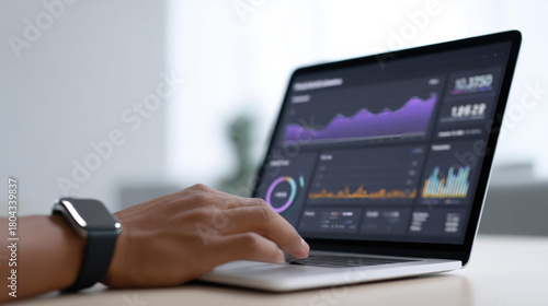 Focused business professional analyzing financial data and stock market charts on laptop. screen shows dashboard with graphs for business intelligence and analytics