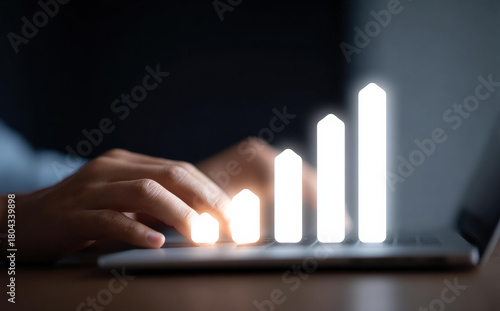 Person typing on laptop with futuristic glowing business chart. concept representing data analysis, technology, growth, progress, and success in digital economy