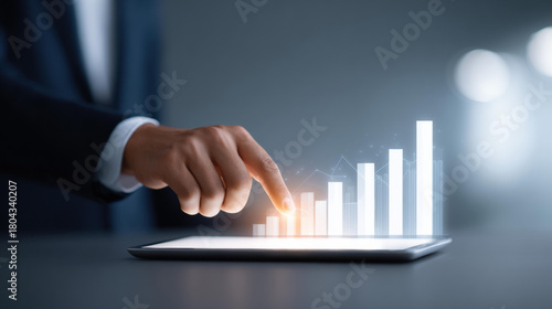 Confident businessman using technology for business growth. Finger touching digital chart, showing finance analysis, successful graph for new investment on tablet
