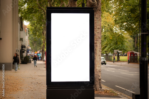 A blank advertising board on busy London street with space for copy, text or generative fill