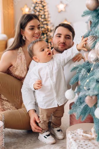 Family joyfully decorating a Christmas tree at home while celebrating the festive season together in a warm and cozy environment