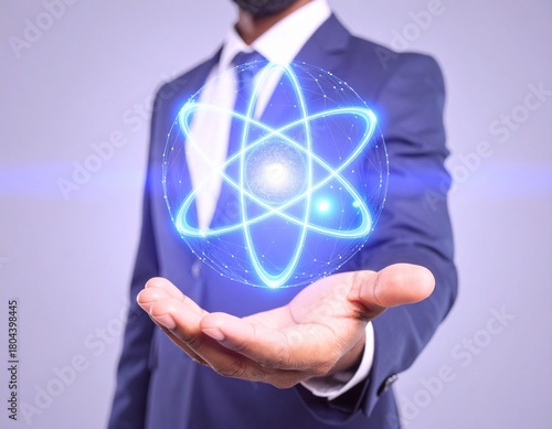 Businessman Holding a Glowing Blue Atomic Model in Hand