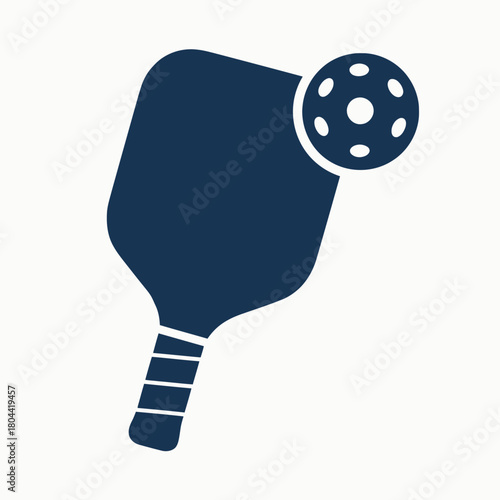 A simple, solid navy blue vector icon illustration of a pickleball paddle paired with a wiffle ball, isolated on a clean white background, representing the popular sport.