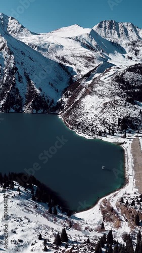 Aerial view of mountain lake at winter with snow