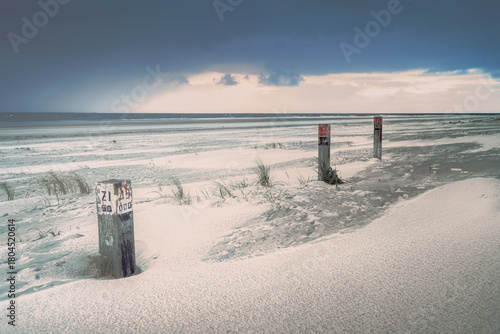 Afternoon seacoast landscape with view on the beach during stormy weather.
