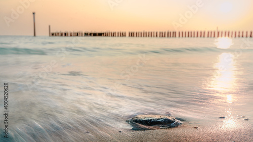 Motion blur Waves at the sea during sunset at Dutch coast of Zeeland