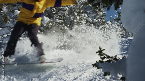 Snowboarder rides and jumps offpiste between pine trees. Backcountry at ski resort video 120p